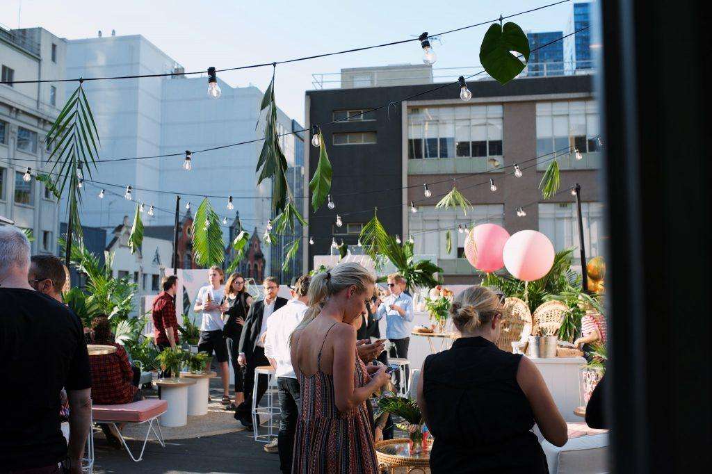 Vibrant rooftop dining event with private chef, lush greenery, and exclusive Australian culinary experience.