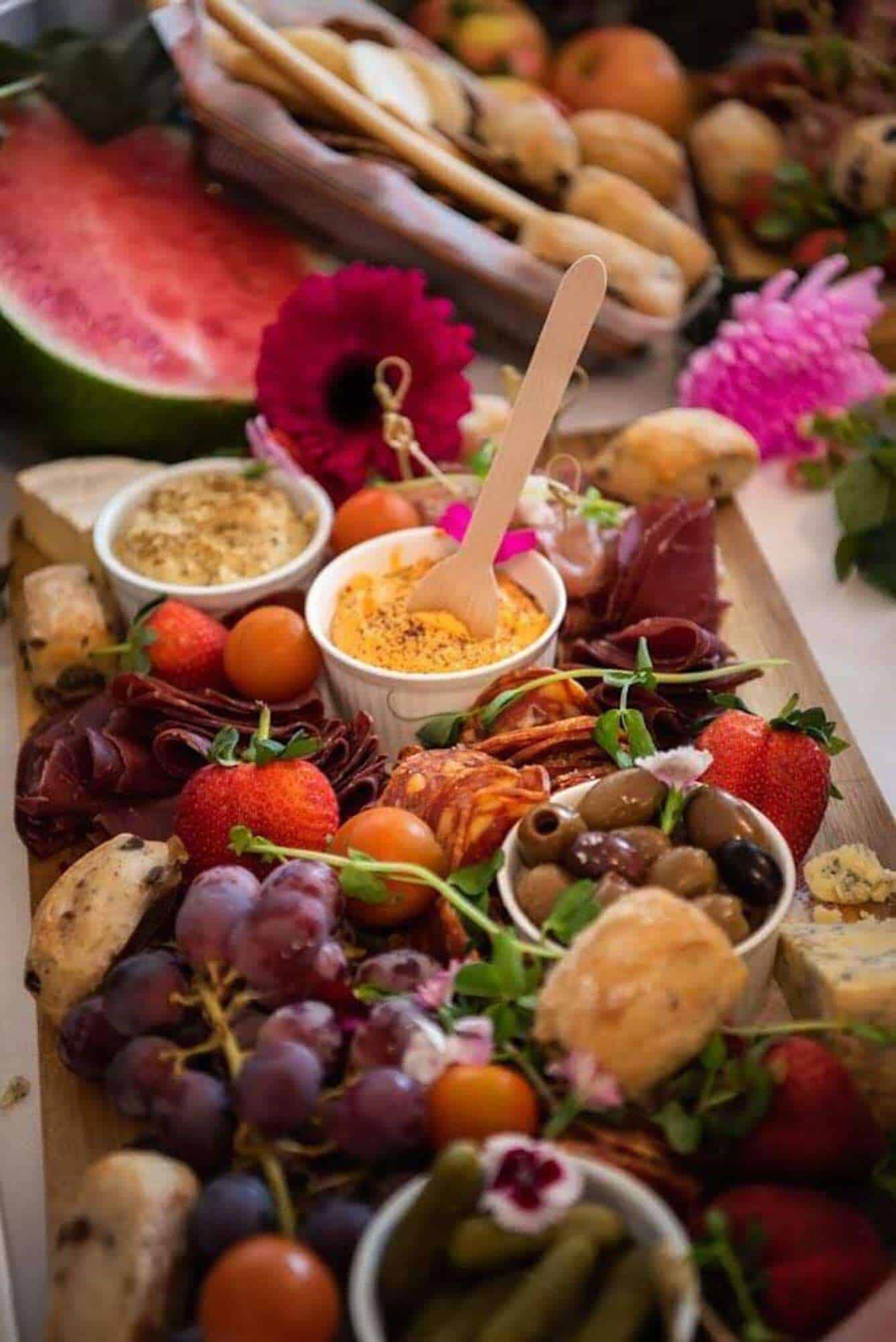 Delicious gourmet antipasto platter with fresh fruits, cheeses, meats, and dips for private events and intimate gatherings.