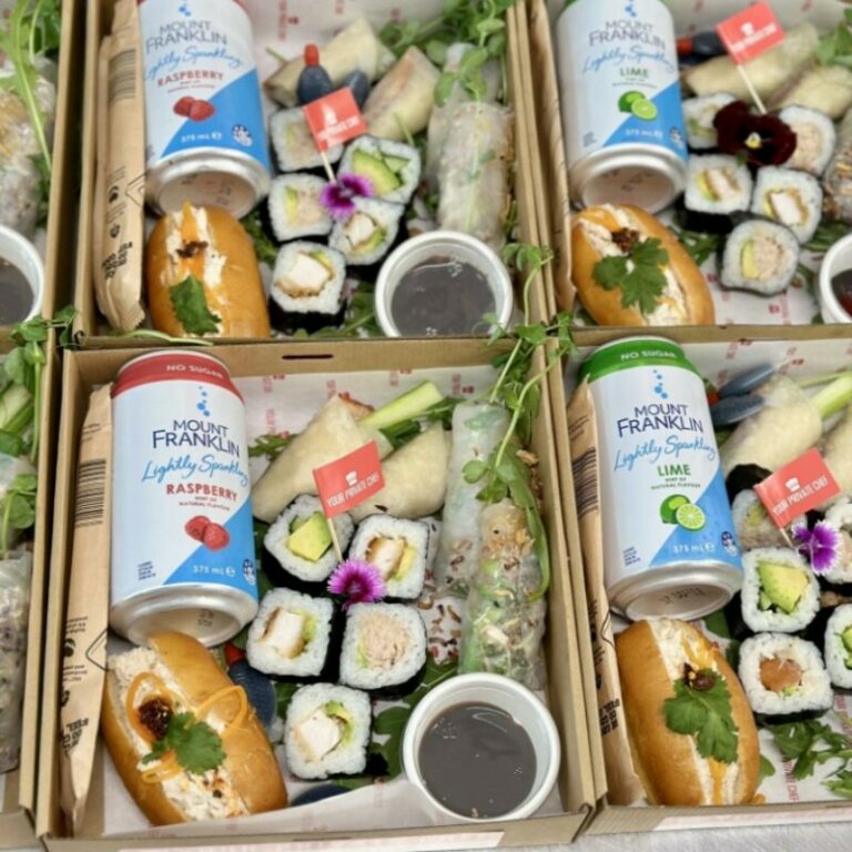 Fresh sushi rolls arranged in wooden boxes, showcasing a variety of colourful, expertly prepared Jap.