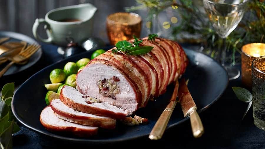 Succulent stuffed roast beef wrapped in bacon, perfect for private chef dining experiences.