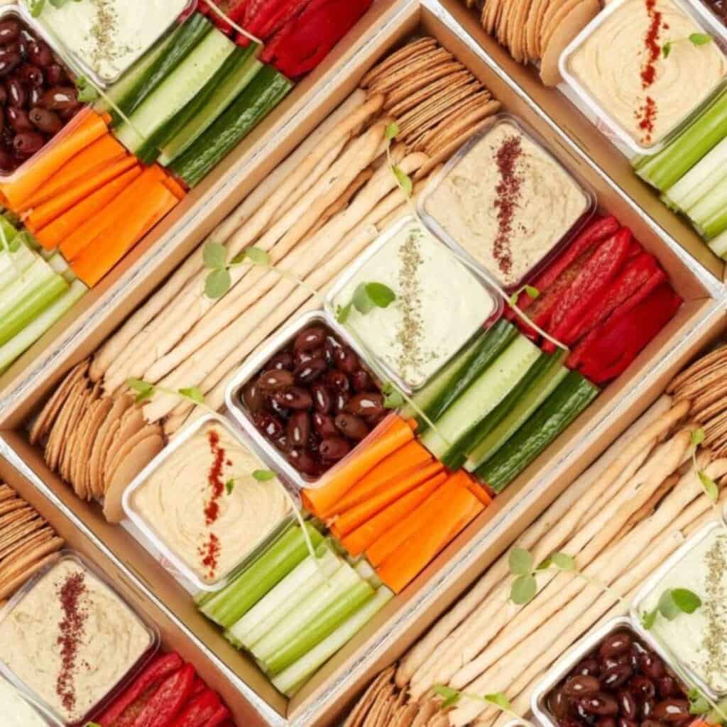 Fresh vegetable and dip platter with carrots, celery, and hummus, perfect for healthy snacking and e.