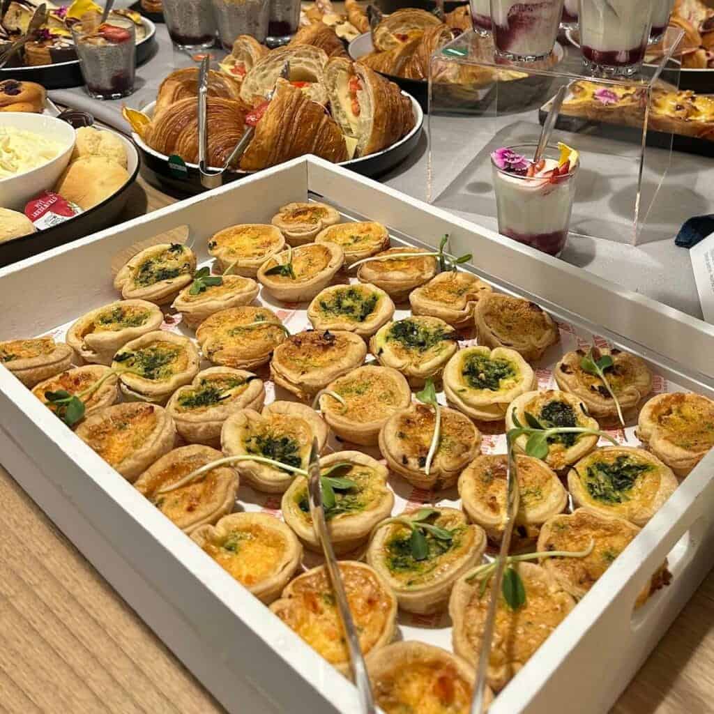 Assorted gourmet mini quiches and appetizers for catering in Australia.